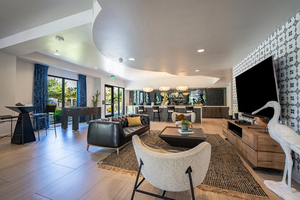 a large living room with a large television and a table