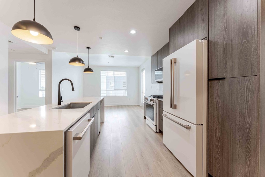 a kitchen with a sink and a refrigerator