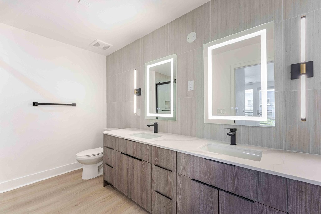 a bathroom with two sinks and a toilet