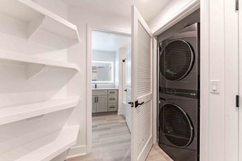 a laundry room with a closet and a washer and dryer