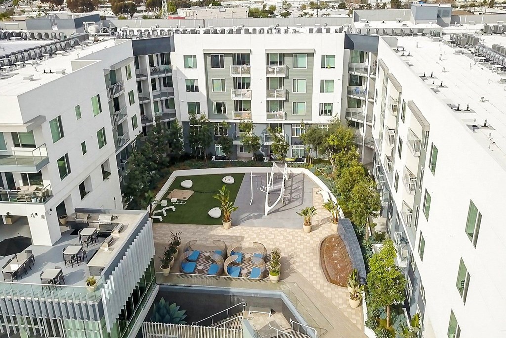 an aerial view of an apartment building with a courtyard and a basketball court