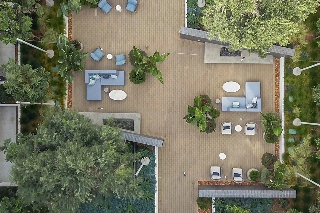 arial view of the backyard with tables and chairs and trees