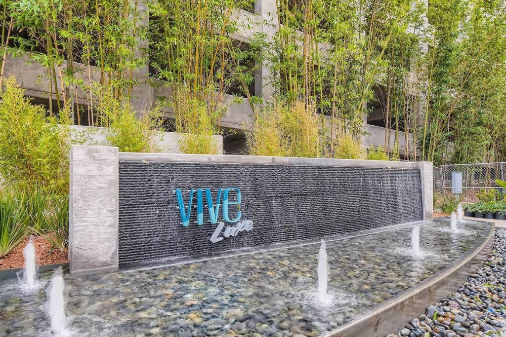 a fountain in front of a building with graffiti on it