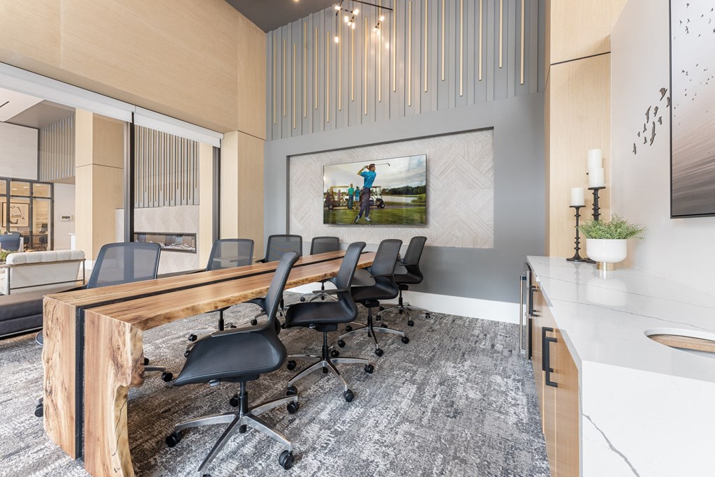 a conference room with a long desk and chairs