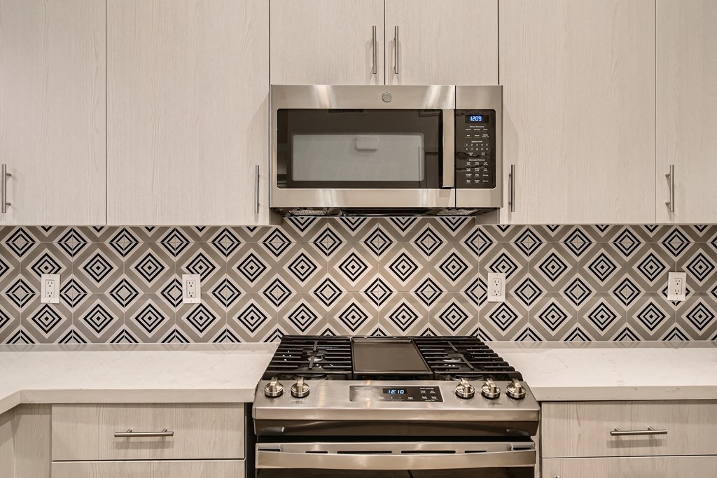 a kitchen with a stove and a microwave