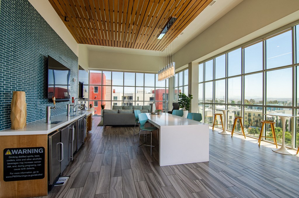a kitchen and living room with large windows and a view of a river
