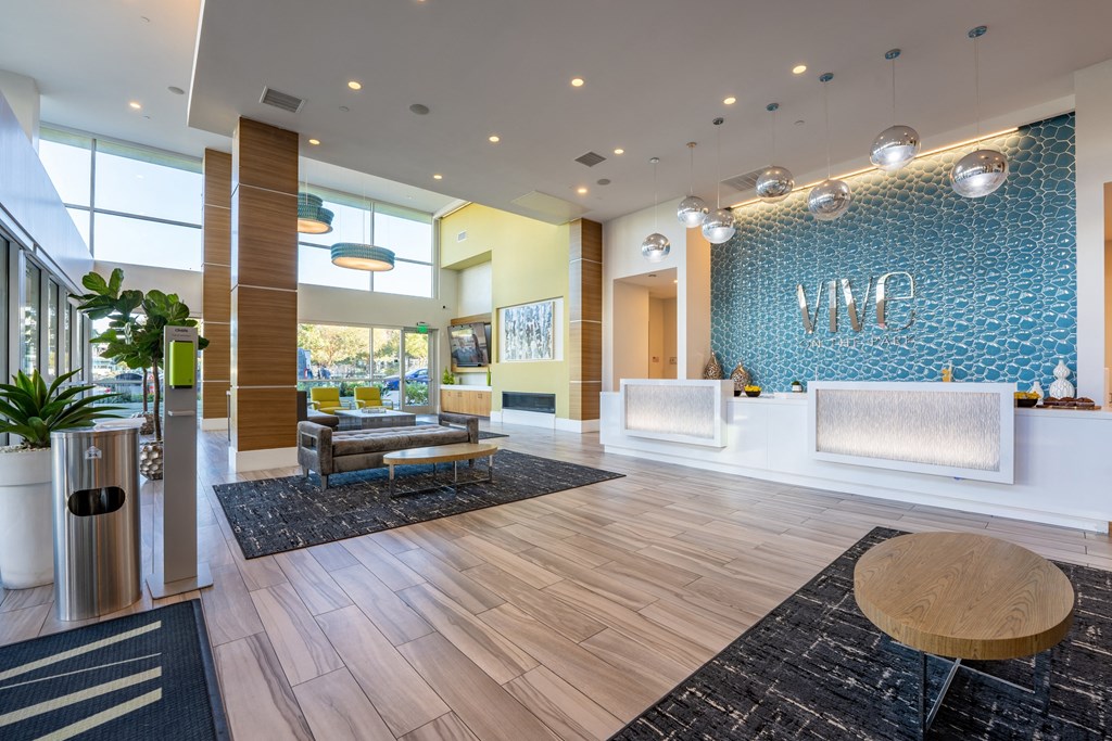 a lobby with a reception desk and a blue and white wall