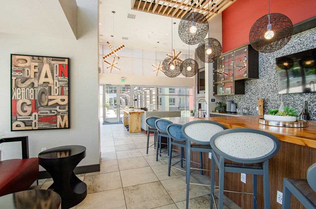 a long bar with blue chairs and a counter in a restaurant