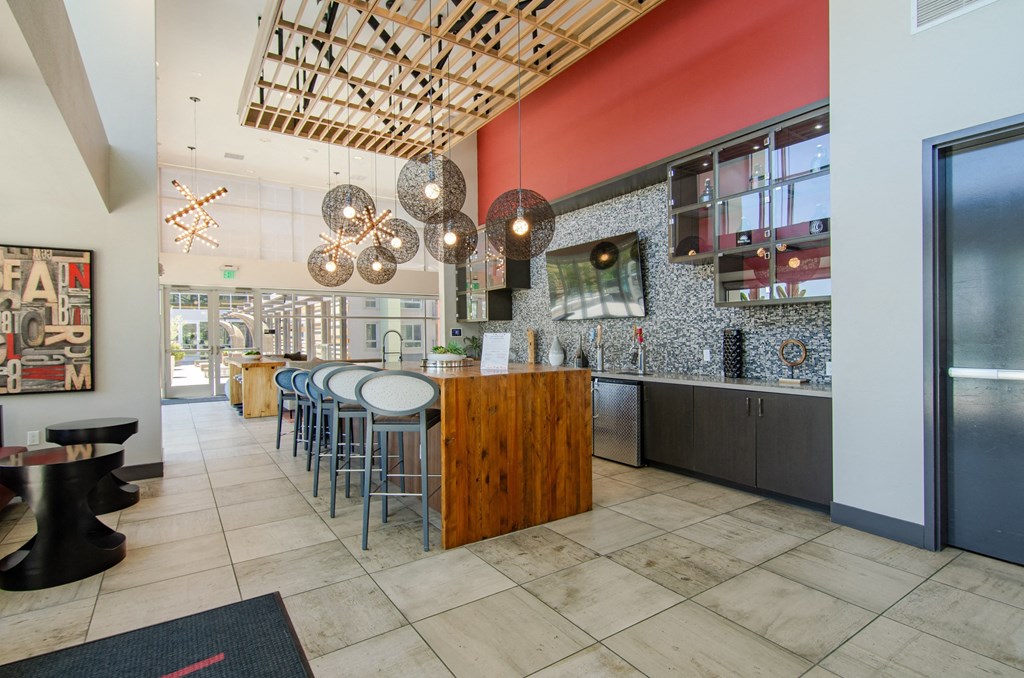 the interior of a restaurant with a bar and tables and chairs