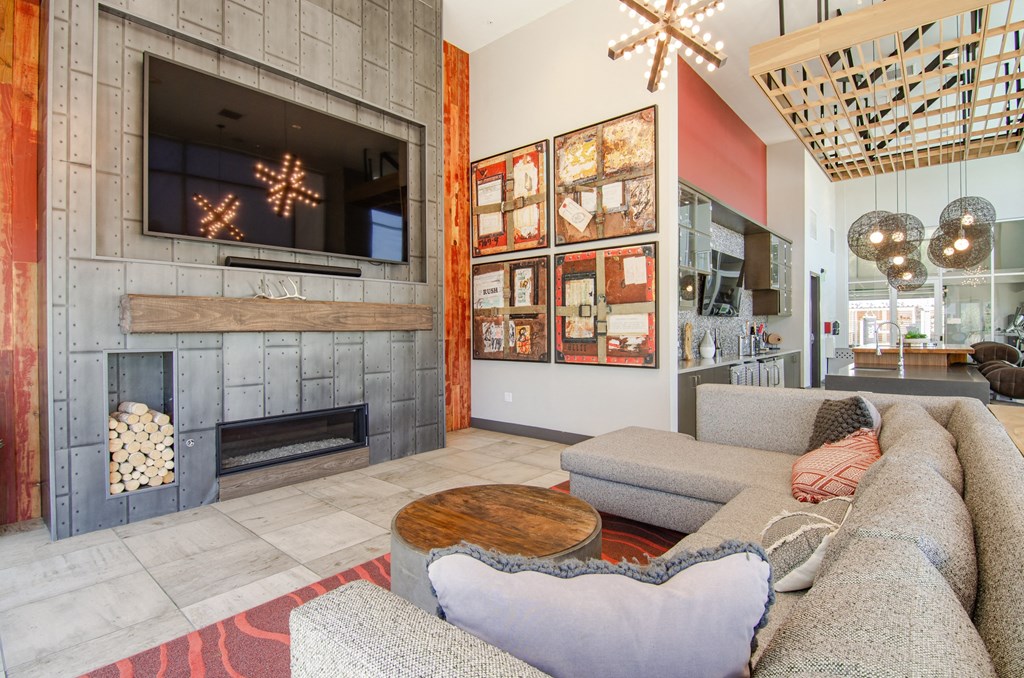 a living room with couches and a tv and a fireplace