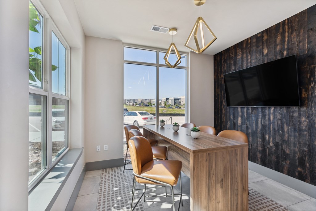 a conference room with a long wooden table and chairs and a large window with a city view