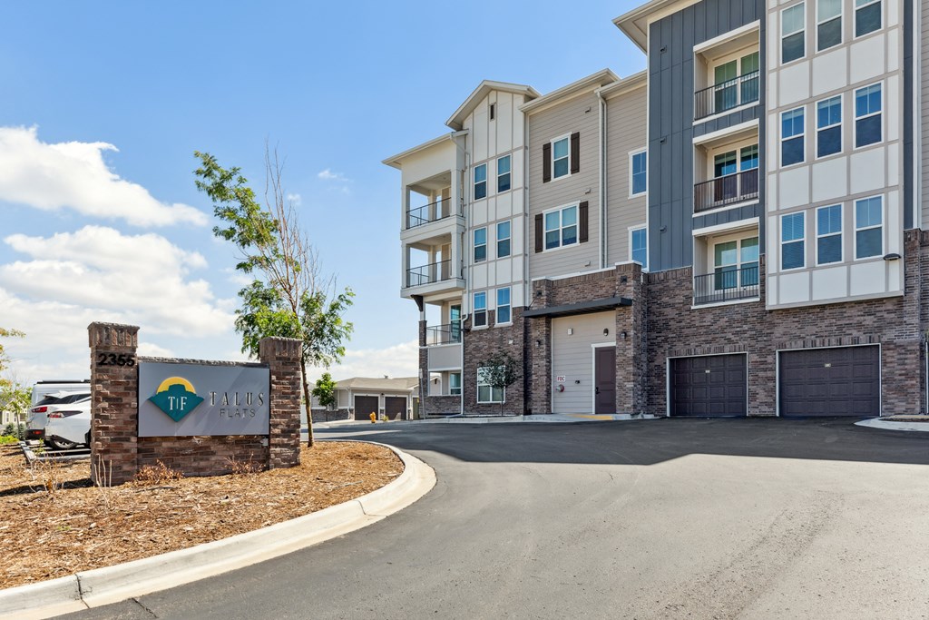 a view of the entrance to the building with a parking lot