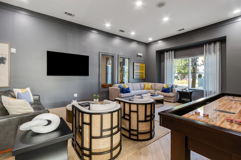 a large living room with couches and a pool table