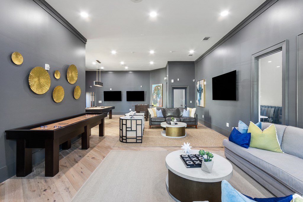 a living room with couches and tables and a ping pong table