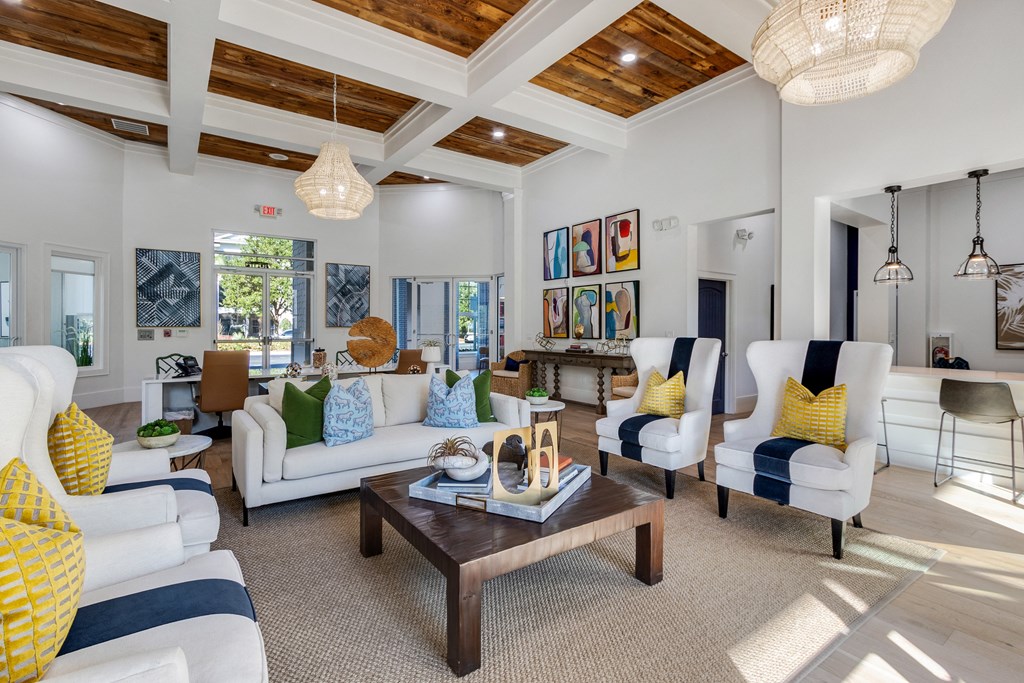 a living room with couches and chairs and a table