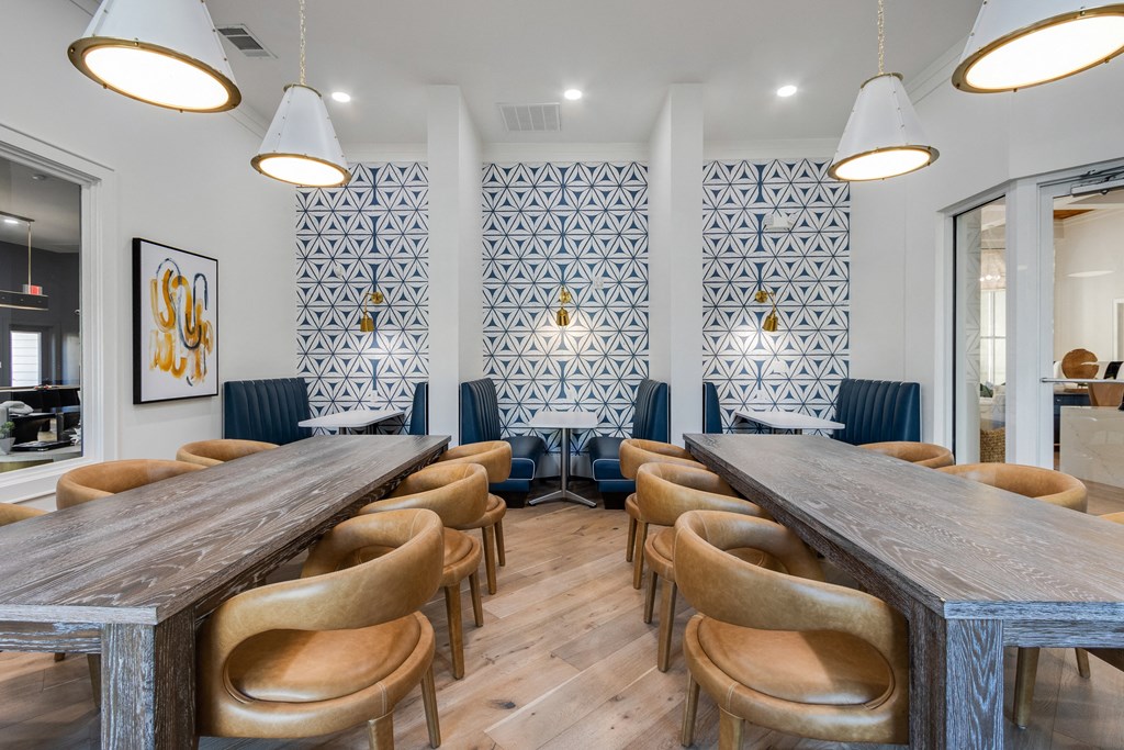a communal table and chairs in a restaurant with blue and white walls