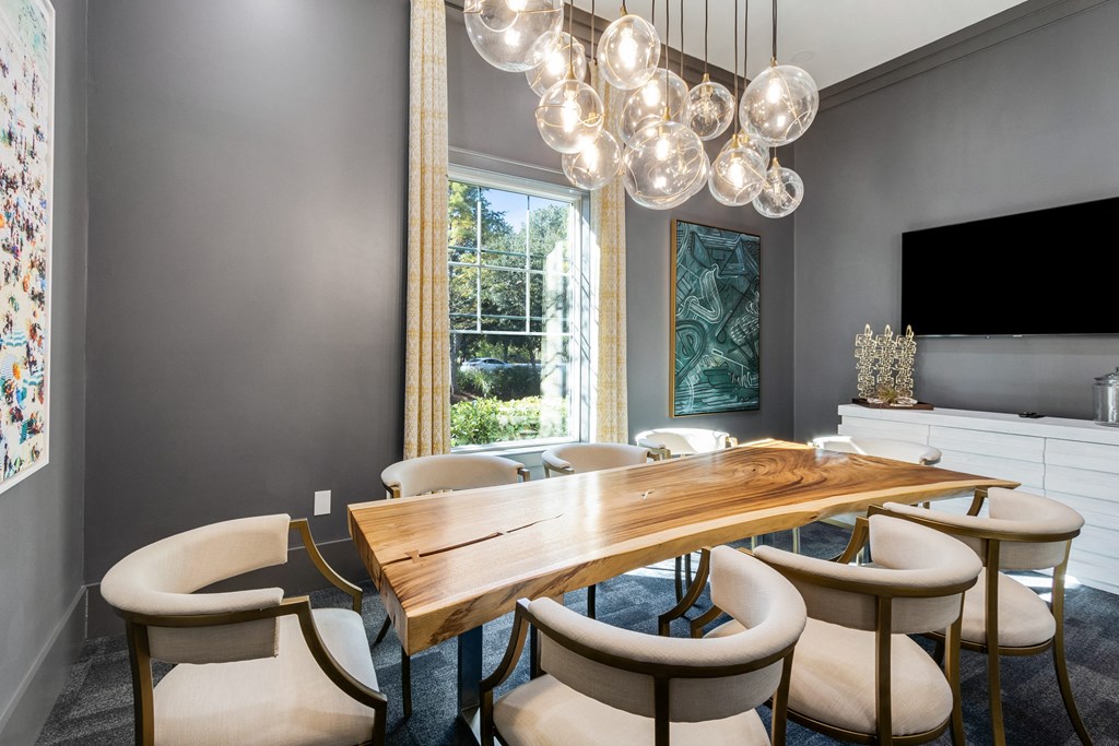a dining room with a long wooden table and chairs