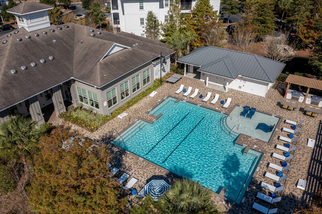 a aerial view of a swimming pool and a house with a pool