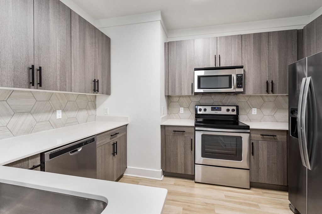 a kitchen with stainless steel appliances and wooden cabinets