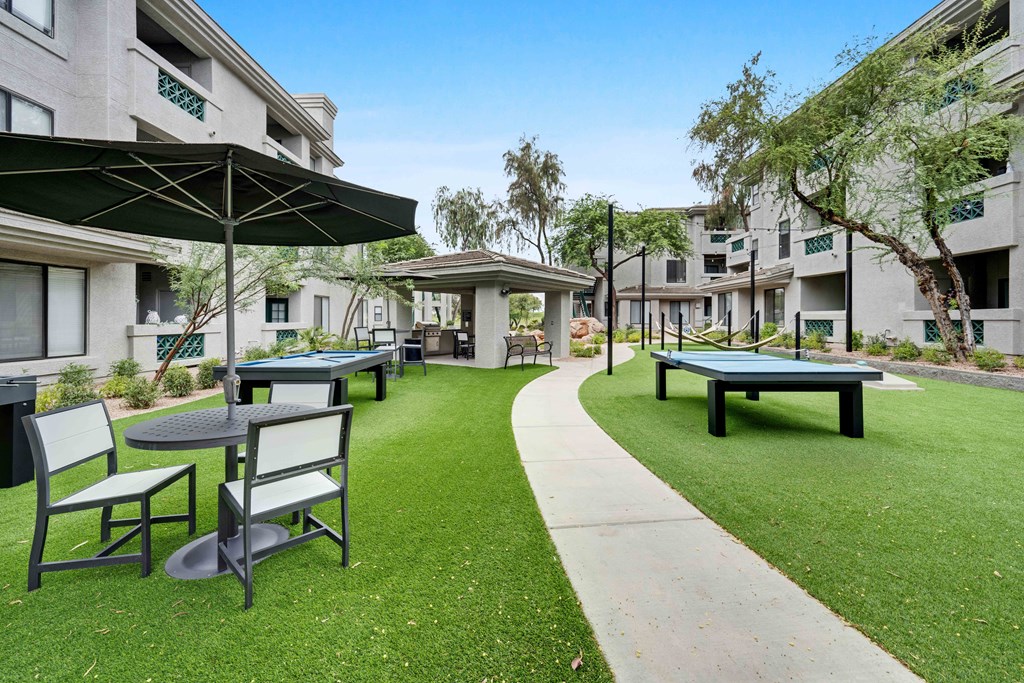 picnic area with tables chairs and umbrellas