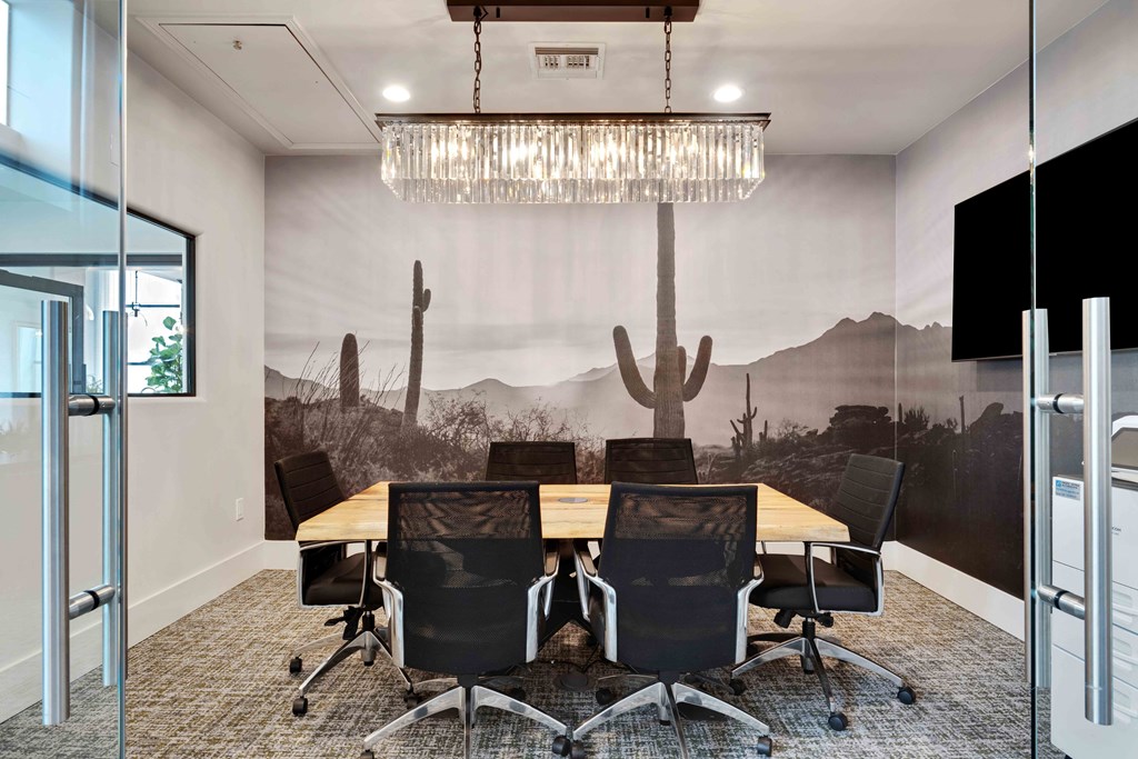 a mural of a desert landscape is painted on the wall of this conference room