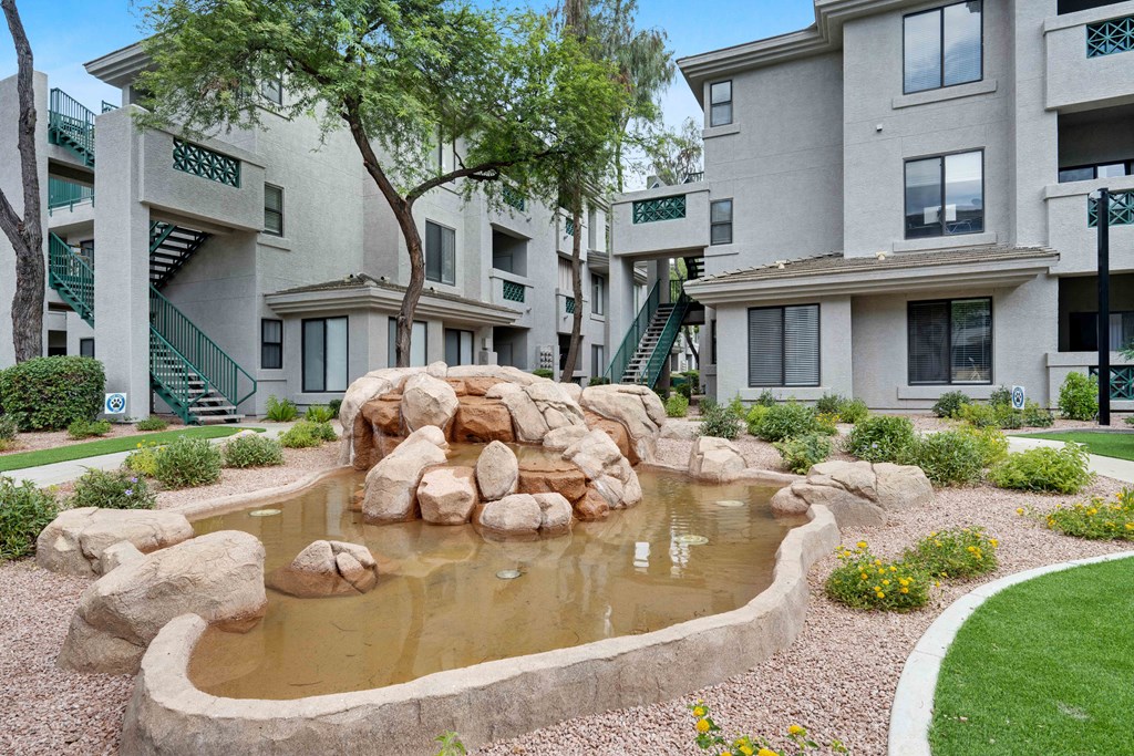a pond sits in the middle of an apartment complex