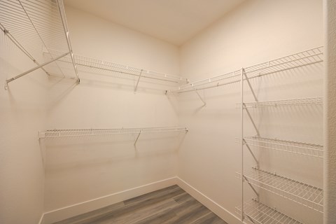 a spacious walk in closet at the whispering winds apartments in pearland, tx