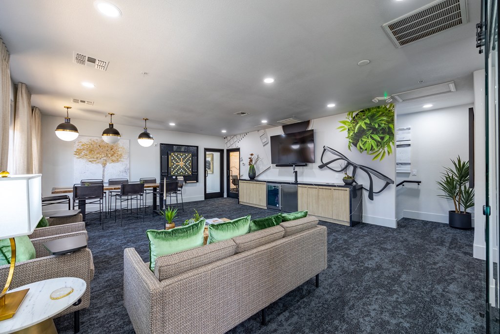 an open concept living room with a kitchen and dining area
