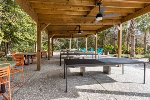 a covered pavilion with tables and chairs