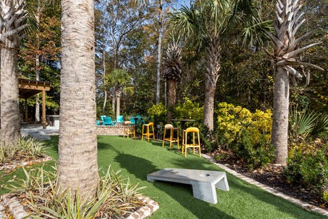 a backyard with artificial turf and palm trees