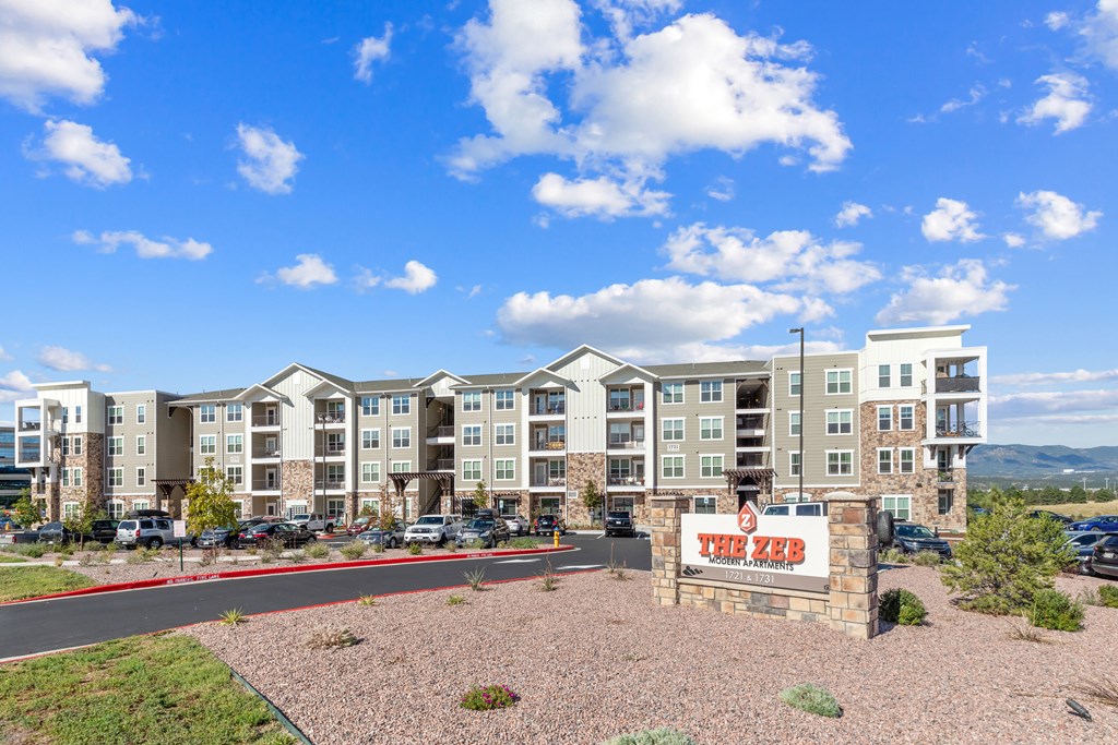 an apartment building with a sign in front of it the zeb