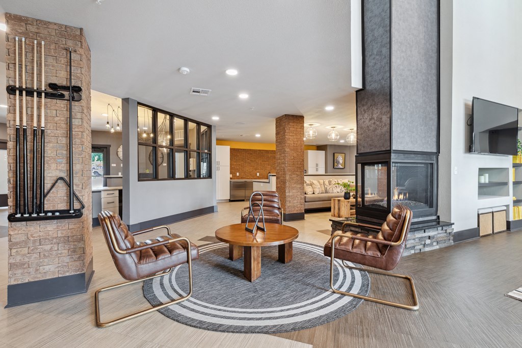 a living room with a fireplace and a table and chairs