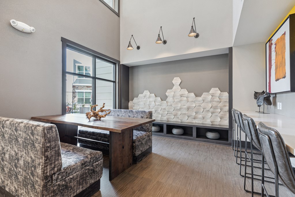 a dining room with a table and chairs and a large window