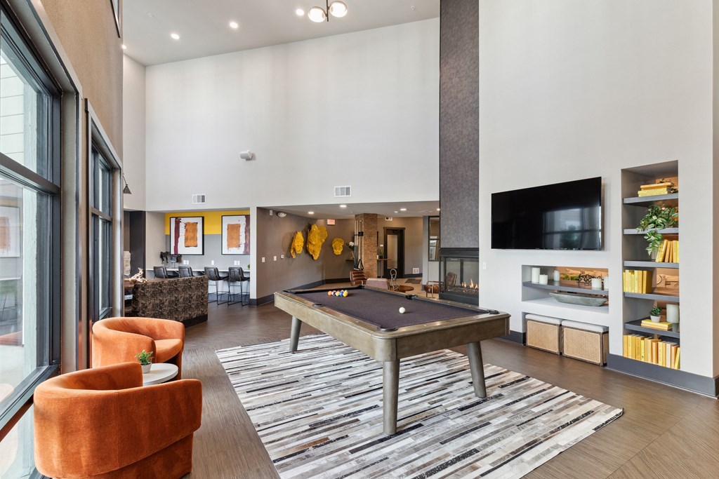 Spacious Residents lounge with large windows that lets in natural light to illuminate the pool table and T.V. area in Colorado Springs, CO