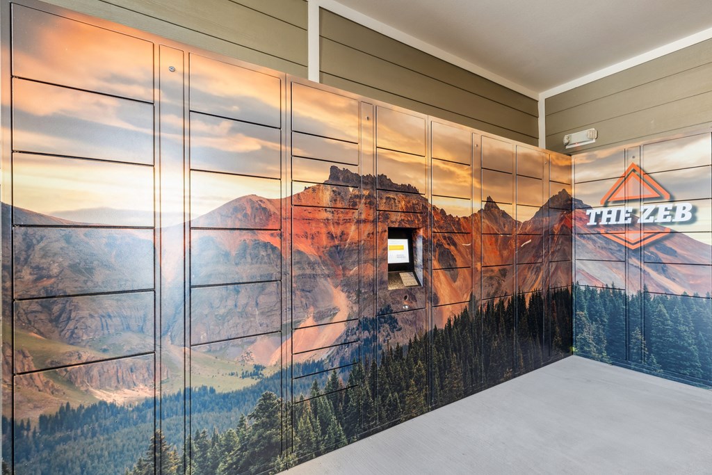 a mural of a mountain on the package lockers at the zeb apartments