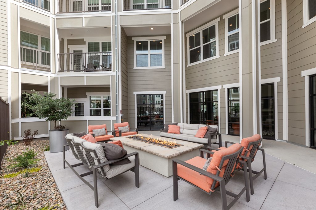 an outdoor living area with a fire pit and patio furniture
