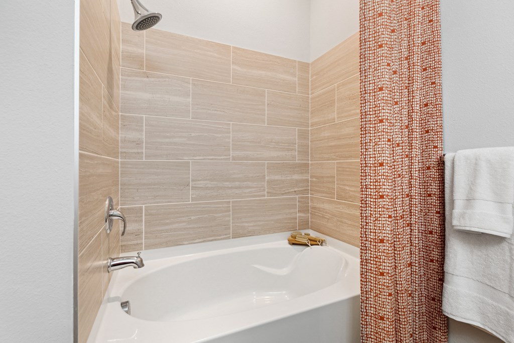 a bathroom with a shower and a bath tub