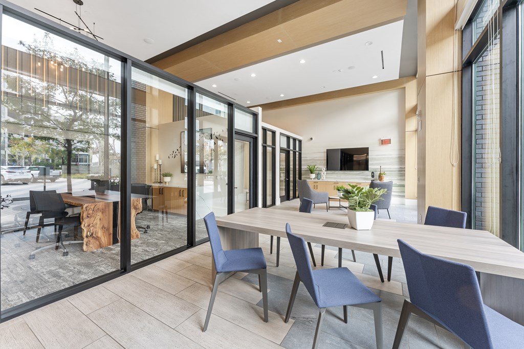 a dining room with a wooden table and chairs