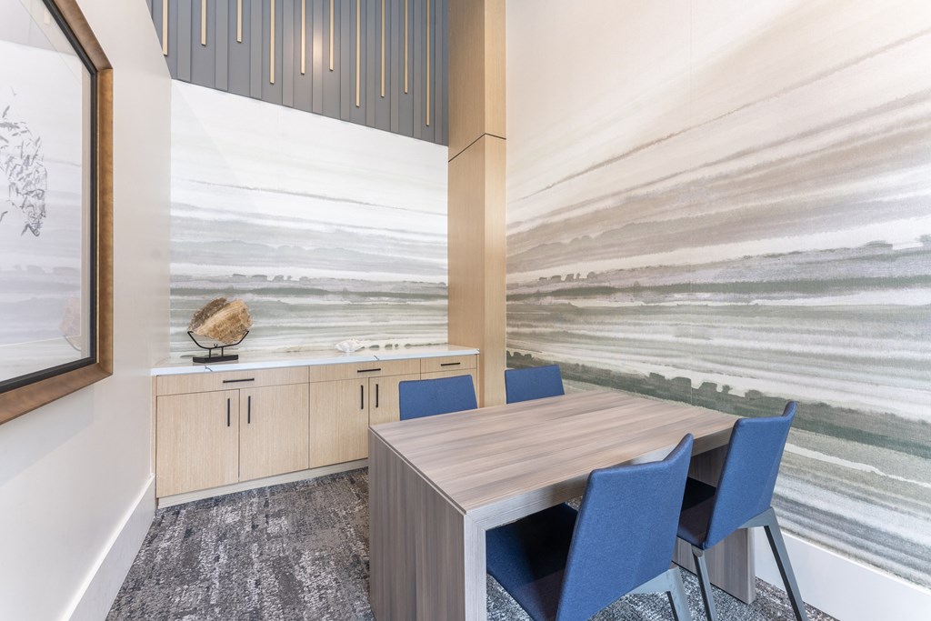 A conference room with a wooden table and blue chairs.