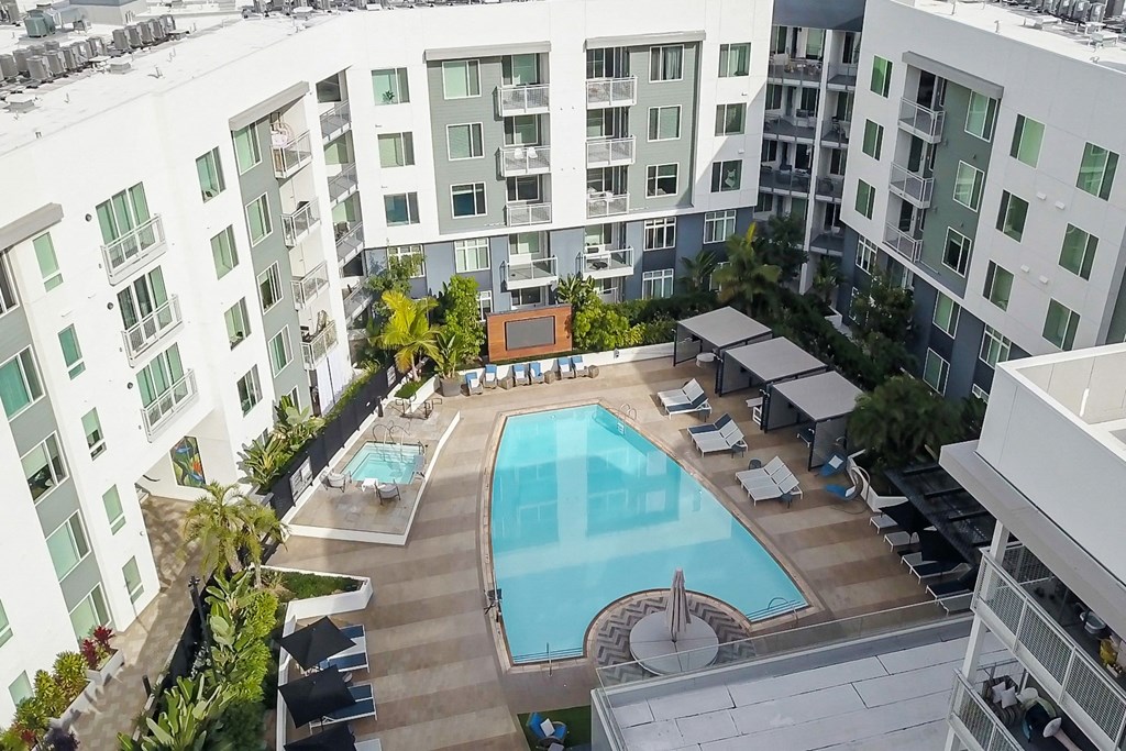 an overhead view of an apartment building with a swimming pool