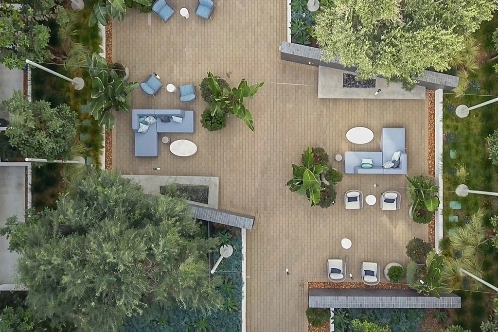 arial view of the backyard with tables and chairs and trees