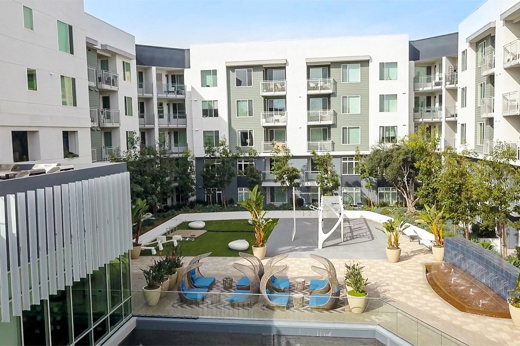 an apartment building with a pool and a courtyard