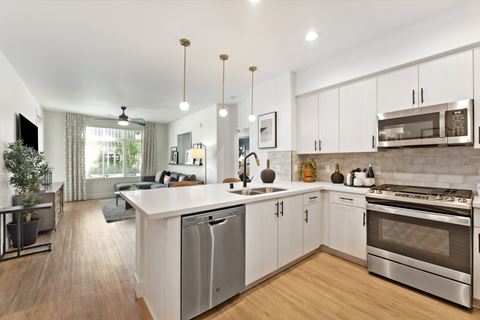 an open kitchen with an island and stainless steel appliances