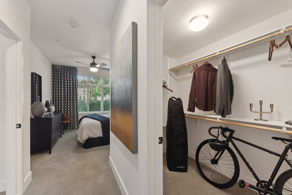 a bedroom with a bike in a room with a closet