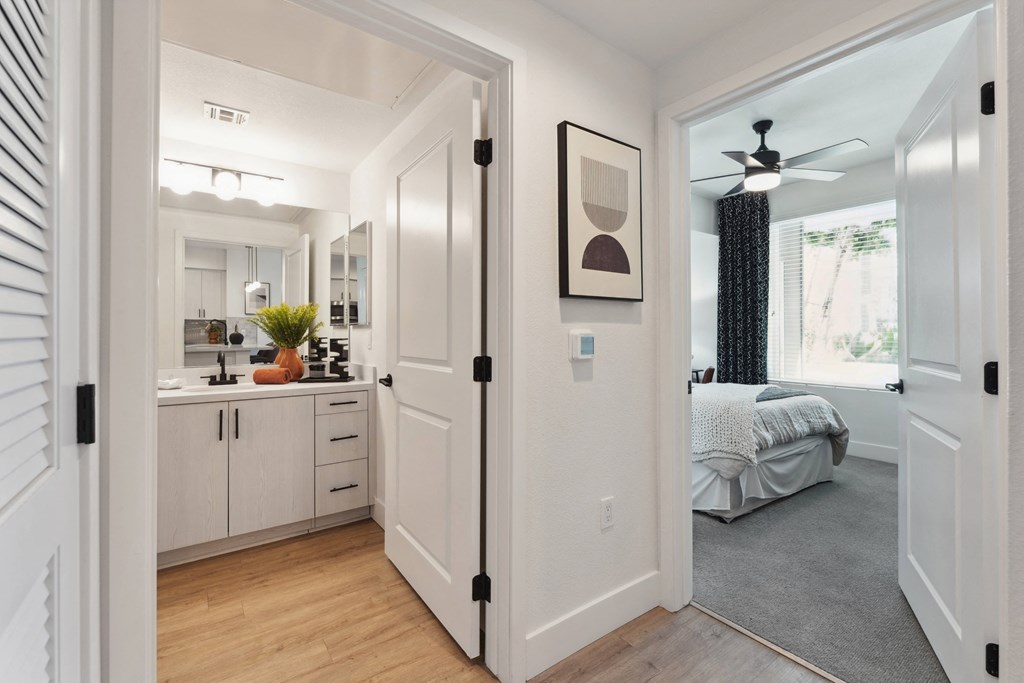 an open kitchen and living room with a bedroom in the distance