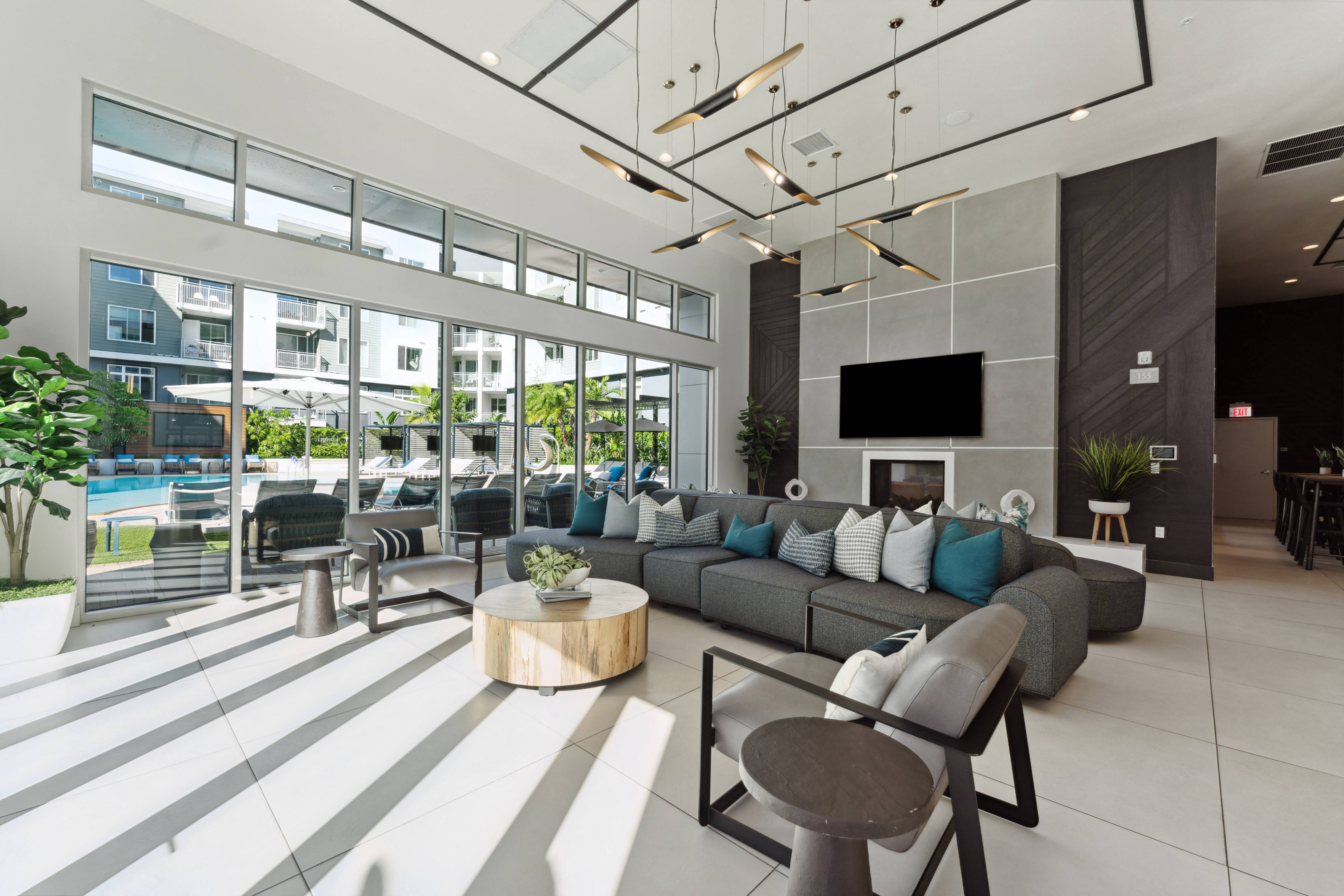 a living room with couches and chairs and a tv