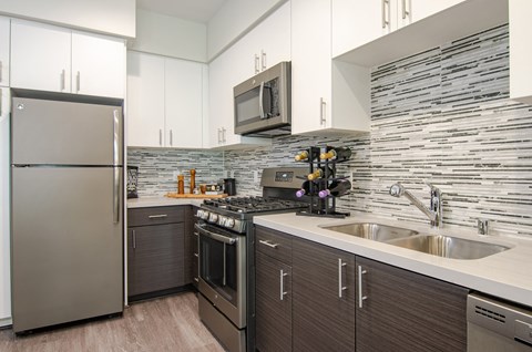 a kitchen with stainless steel appliances and a sink