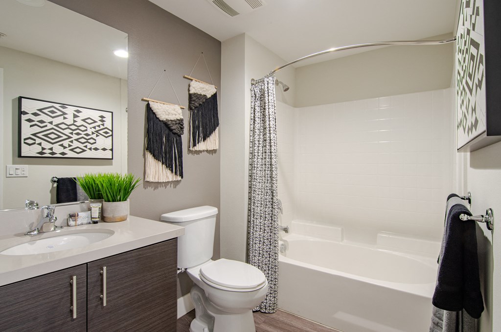 A bathroom with a white toilet, a white sink, and a white bathtub.