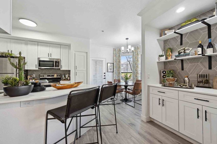 Zone, Glendale, AZ, Kitchen a kitchen with white cabinets and a white counter top with three stools in front of it - Photo Gallery
