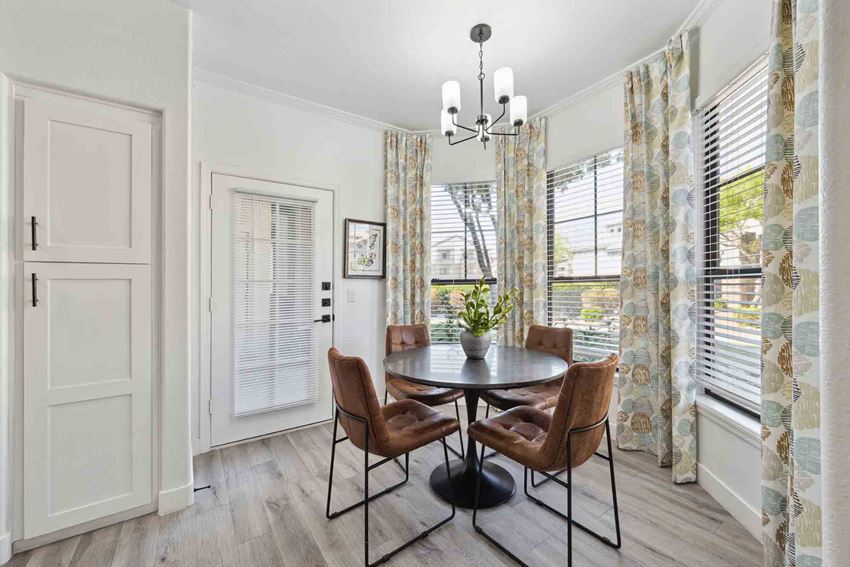 Zone, Glendale, AZ, Dining Area a dining room with a round table with four chairs and a chandelier - Photo Gallery